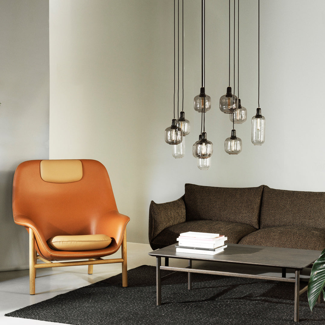 Fauteuil de salon contemporain à dossier haut et tapissé, avec silhouette organique drapée et pieds en chêne pour le salon