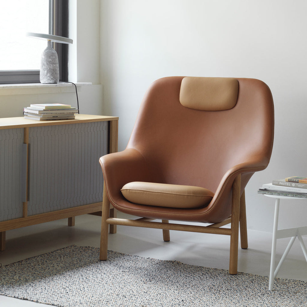 Fauteuil de salon contemporain à dossier haut et tapissé, avec silhouette organique drapée et pieds en chêne pour le salon