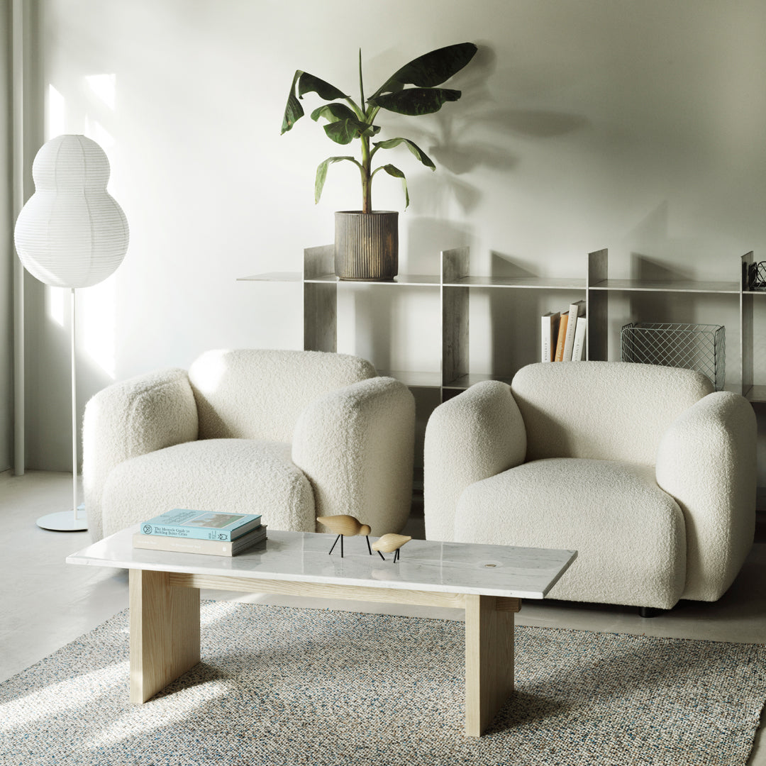 Fauteuil de salon rembourré minimaliste avec silhouette aux courbes douces pour le salon